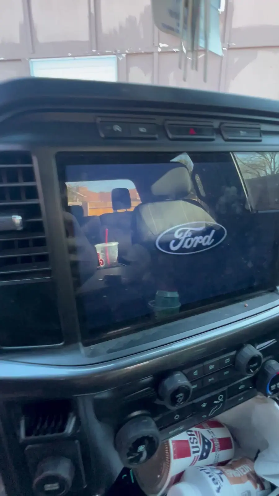Cluttered center console and dashboard of the Ford F-150 before cleaning
