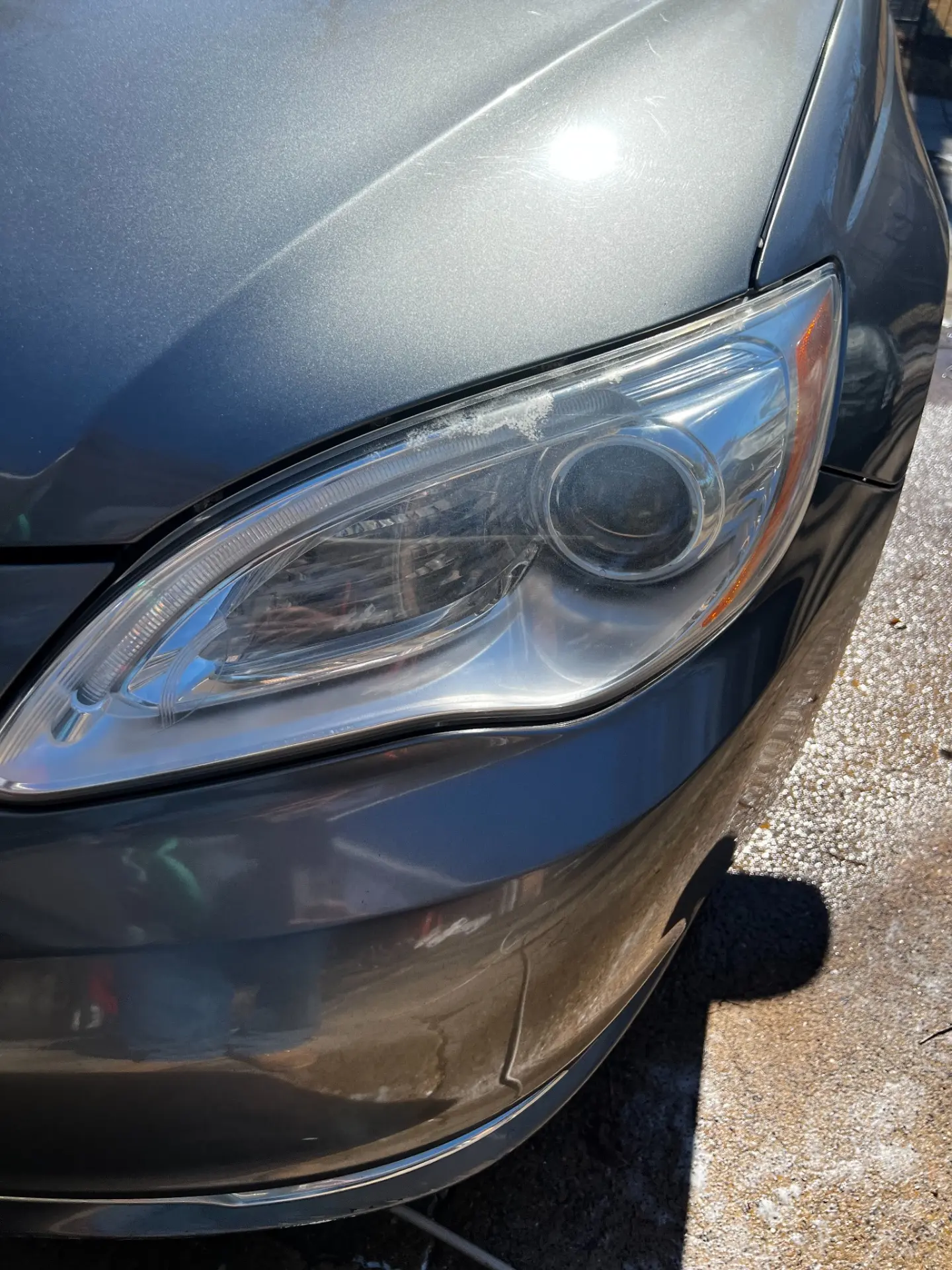 Cloudy, hazy headlight lens on the Chrysler 200 before restoration